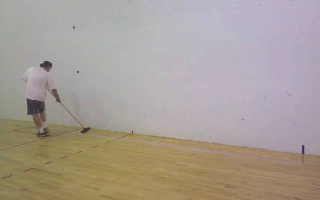 Refinishing a hardwood floor on a Racquet Ball Court