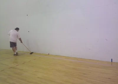 Refinishing a hardwood floor on a Racquet Ball Court